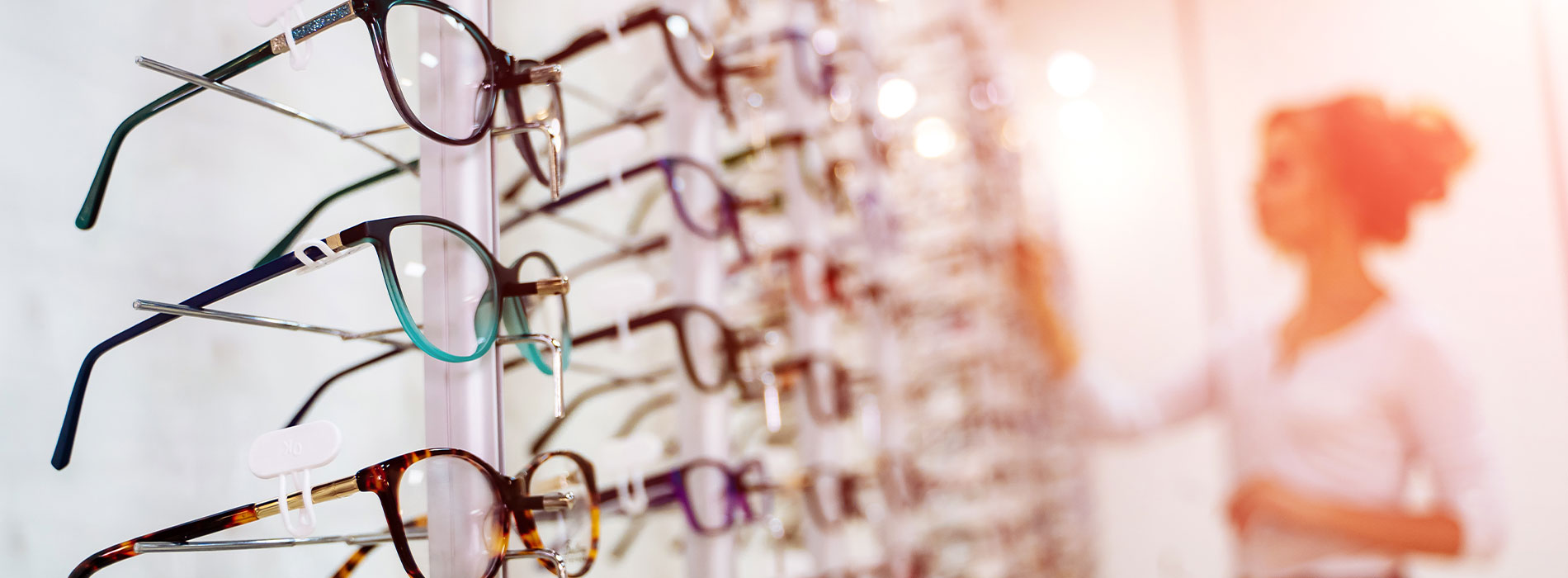 A well-lit reception area with a desk, computer monitor, and potted plant.