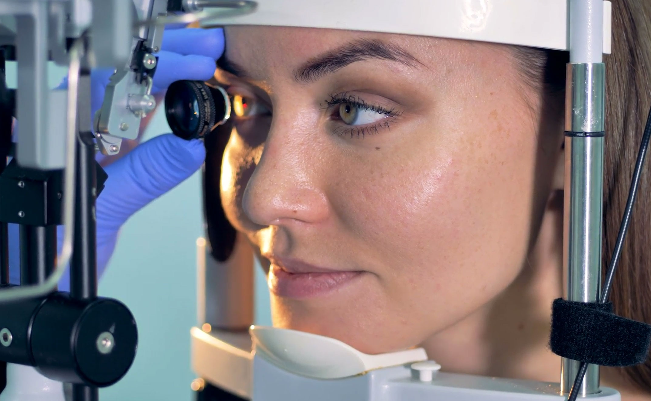 The image shows a modern dental or medical office interior with a dental chair, equipment, and a clean, professional environment.